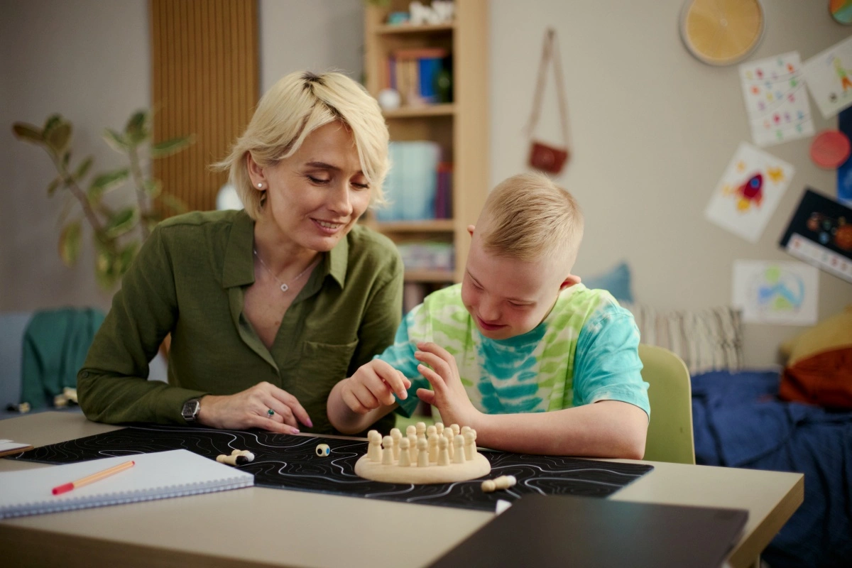 sent teaching assistant with student with a wooden board game