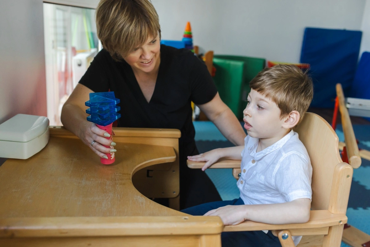 sen teaching assistant with student at a table